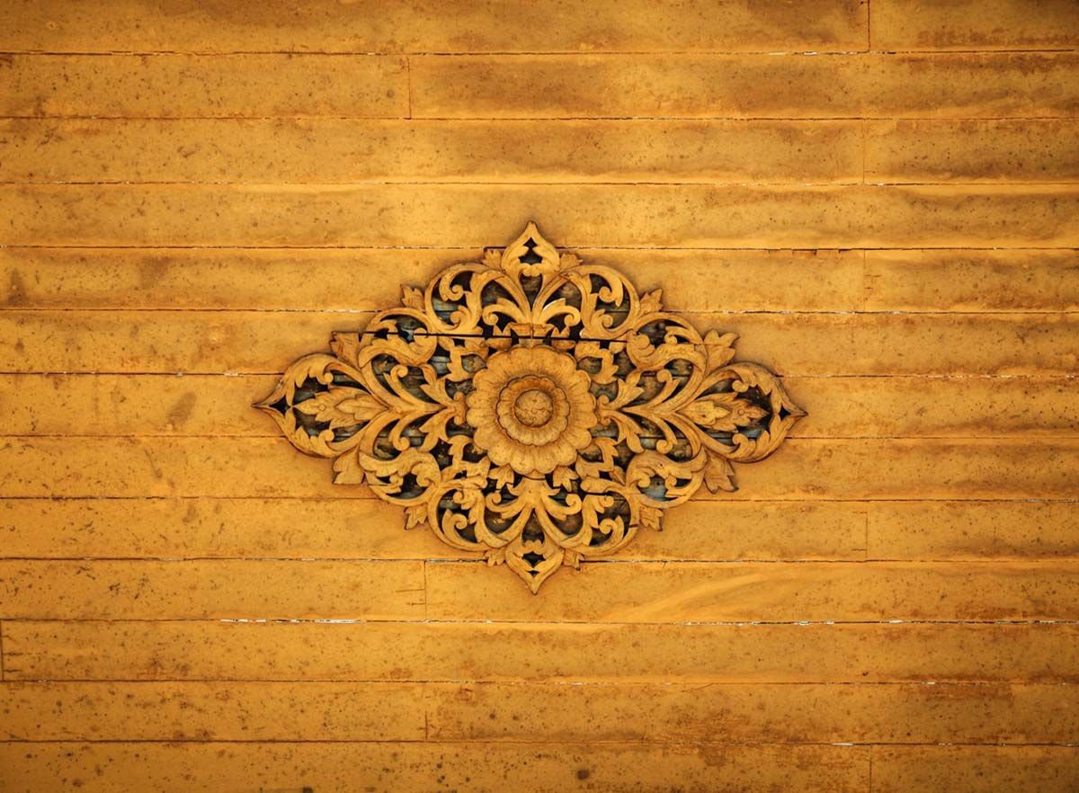 Yellow washed intricate Indian wooden carving pattern